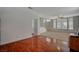 Bright living room featuring hardwood floors, a staircase, and a large window at 7650 Hartwell Dr, Las Vegas, NV 89123