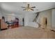 Open-concept living room featuring a staircase, carpeted area, and tiled entry at 7650 Hartwell Dr, Las Vegas, NV 89123