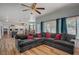 Bright and airy living room showcasing a large sectional sofa and wood-style floors at 7650 Hartwell Dr, Las Vegas, NV 89123