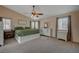 Spacious main bedroom with neutral walls, a large bed, a ceiling fan, and natural light at 7650 Hartwell Dr, Las Vegas, NV 89123