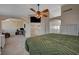 Main bedroom area includes a large bed, ceiling fan, and a view into a lounge area with a desk at 7650 Hartwell Dr, Las Vegas, NV 89123