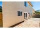 A view of the backyard patio and the home's exterior showing door access to the outdoor space at 7752 Orchard Wood Ct, Las Vegas, NV 89131