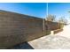 A backyard featuring stone-tiled ground and a tall block wall with desert landscaping at 7752 Orchard Wood Ct, Las Vegas, NV 89131