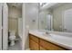 Well-lit bathroom featuring a shower-tub combo and vanity with sink at 7752 Orchard Wood Ct, Las Vegas, NV 89131