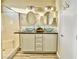 Bathroom featuring double sinks, modern fixtures, and a shower with white subway tile at 7752 Orchard Wood Ct, Las Vegas, NV 89131