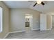 Bright bedroom with window, ceiling fan, and view to bathroom and closet space at 7752 Orchard Wood Ct, Las Vegas, NV 89131