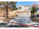 Charming two-story home featuring a classic design, two-car garage, and a well-maintained front yard at 7752 Orchard Wood Ct, Las Vegas, NV 89131