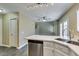 Well-lit kitchen area with quartz countertops, stainless appliances, and an open view to the living room at 7752 Orchard Wood Ct, Las Vegas, NV 89131