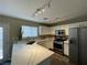 Well-lit kitchen featuring stainless steel appliances, marble countertops, and ample storage space in white cabinetry at 7752 Orchard Wood Ct, Las Vegas, NV 89131