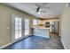 Bright kitchen with white cabinetry, marble countertops and stainless steel appliances, adjacent to french doors at 7752 Orchard Wood Ct, Las Vegas, NV 89131