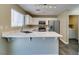 Modern kitchen with stainless appliances, stone countertops, and ample cabinet space at 7752 Orchard Wood Ct, Las Vegas, NV 89131