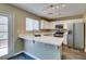 Stylish kitchen features white cabinets, marble countertops, and stainless steel appliances under modern lighting at 7752 Orchard Wood Ct, Las Vegas, NV 89131