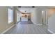 Open concept living room featuring modern flooring flowing into the adjacent kitchen area with stainless appliances at 7752 Orchard Wood Ct, Las Vegas, NV 89131