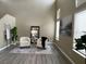 Bright living room featuring high ceilings, neutral walls, luxury vinyl plank flooring, and elegant decor at 7752 Orchard Wood Ct, Las Vegas, NV 89131