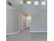 Open living room showcasing staircase, front door, and light gray wood-look floors at 7752 Orchard Wood Ct, Las Vegas, NV 89131