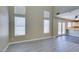 Spacious living room with plenty of natural light from the high windows, connected to the kitchen area at 7752 Orchard Wood Ct, Las Vegas, NV 89131