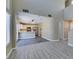 Bright living room features stairs, seamless transition to the kitchen, and modern flooring at 7752 Orchard Wood Ct, Las Vegas, NV 89131