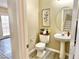 Cozy powder room with pedestal sink, decorative accents, and modern fixtures at 7752 Orchard Wood Ct, Las Vegas, NV 89131