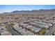 An aerial view captures this property and others in a well-maintained neighborhood nestled against a backdrop of picturesque mountains at 7970 Calito St, Las Vegas, NV 89166