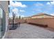 Open backyard with a brick patio, a dining table with umbrella, and a view of neighboring homes at 7970 Calito St, Las Vegas, NV 89166