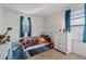 bedroom featuring carpet, a white dresser, and a twin bed with colorful bedding and blue drapes at 7970 Calito St, Las Vegas, NV 89166