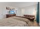 Cozy bedroom featuring a comfortable bed, a brown futon, and stylish coastal decor at 7970 Calito St, Las Vegas, NV 89166