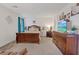 Inviting bedroom with wood furniture, neutral bedding, and beach-themed wall decor at 7970 Calito St, Las Vegas, NV 89166