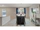 Elegant dining area with a modern table and a decorative mirror, bathed in natural light at 7970 Calito St, Las Vegas, NV 89166