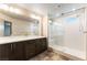 This bathroom offers dual vanities, a glass-enclosed shower, and contemporary lighting for a sleek design at 8012 Carpenter Creek Ave, Las Vegas, NV 89113