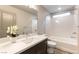 Well lit bathroom with a shower and tub combination and modern finishes at 8012 Carpenter Creek Ave, Las Vegas, NV 89113