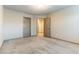 Bright bedroom features neutral walls, plush carpet, and a doorway, creating a calming atmosphere at 8012 Carpenter Creek Ave, Las Vegas, NV 89113