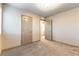 Neutral bedroom with carpet flooring and two doorways at 8012 Carpenter Creek Ave, Las Vegas, NV 89113