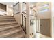 View of the staircase with modern railings and front door to the home at 8012 Carpenter Creek Ave, Las Vegas, NV 89113