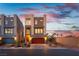 Modern two-story home features clean lines, neutral tones, a rooftop deck, and a two-car garage with a red door at 8012 Carpenter Creek Ave, Las Vegas, NV 89113