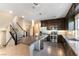 Modern kitchen with stainless steel appliances, dark cabinets, granite countertops, and tile flooring, plus a center island at 8012 Carpenter Creek Ave, Las Vegas, NV 89113