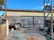 View of metal storage building showing door, storage, and items on the floor and shelving at 81 W Mesquite Ave, Pahrump, NV 89060