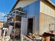 View of metal storage building showing door, storage, and items stored outside the building at 81 W Mesquite Ave, Pahrump, NV 89060