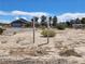 Garage and yard featuring sparse desert vegetation and bright sunny sky at 81 W Mesquite Ave, Pahrump, NV 89060