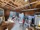 Garage interior with overhead door, metal shelving, and storage of materials and equipment at 81 W Mesquite Ave, Pahrump, NV 89060