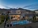 Contemporary home featuring a pool, outdoor seating, and views of the mountains at 826 Willits St, Las Vegas, NV 89138