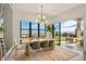 Bright dining area with large windows, a modern chandelier, and access to a beautifully landscaped outdoor patio at 826 Willits St, Las Vegas, NV 89138