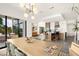 Open-concept dining area with stylish lighting, seamlessly connecting to the modern kitchen and outdoor patio at 826 Willits St, Las Vegas, NV 89138