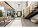 Grand foyer with high ceilings, a modern staircase, and seamless indoor-outdoor flow to the patio at 826 Willits St, Las Vegas, NV 89138