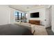 Main bedroom with a view, featuring a wall-mounted TV, wood dresser, and comfortable seating area at 826 Willits St, Las Vegas, NV 89138