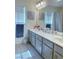 Bright bathroom with a double vanity, neutral tones, and large mirrors, offering a serene and functional space at 8573 Silver Coast St, Las Vegas, NV 89139