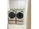 Convenient laundry room with dual washer and dryer units and white cabinets at 8573 Silver Coast St, Las Vegas, NV 89139