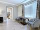 Inviting living room featuring two gray chairs, modern table, and an arched entrance at 8573 Silver Coast St, Las Vegas, NV 89139