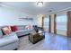 Comfortable living room featuring gray wood floors, neutral walls, and a gray sectional sofa at 8573 Silver Coast St, Las Vegas, NV 89139