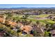 Scenic aerial view of the golf course community showcasing mature trees, and mountain views at 8649 Robinson Ridge Dr, Las Vegas, NV 89117