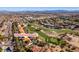 Community aerial view showcasing lush golf course with mature trees and city skyline in the background at 8649 Robinson Ridge Dr, Las Vegas, NV 89117